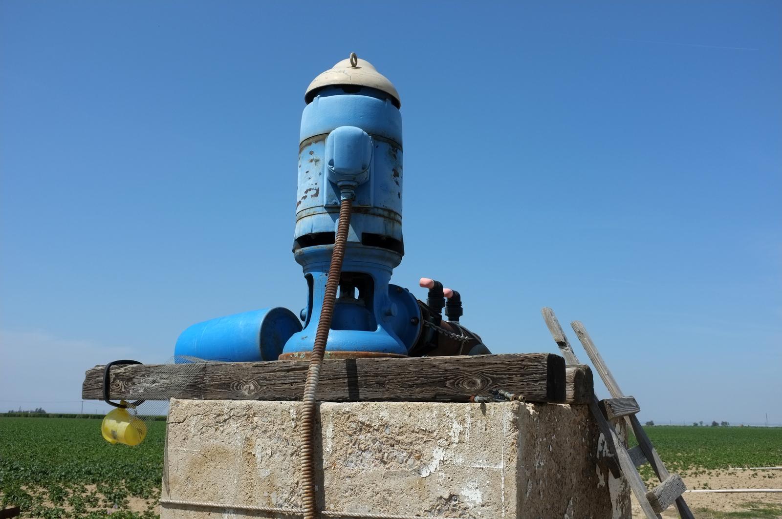 Irrigation pump operating in an agricultural setting where surplus pump equipment may be sold after project or system changes