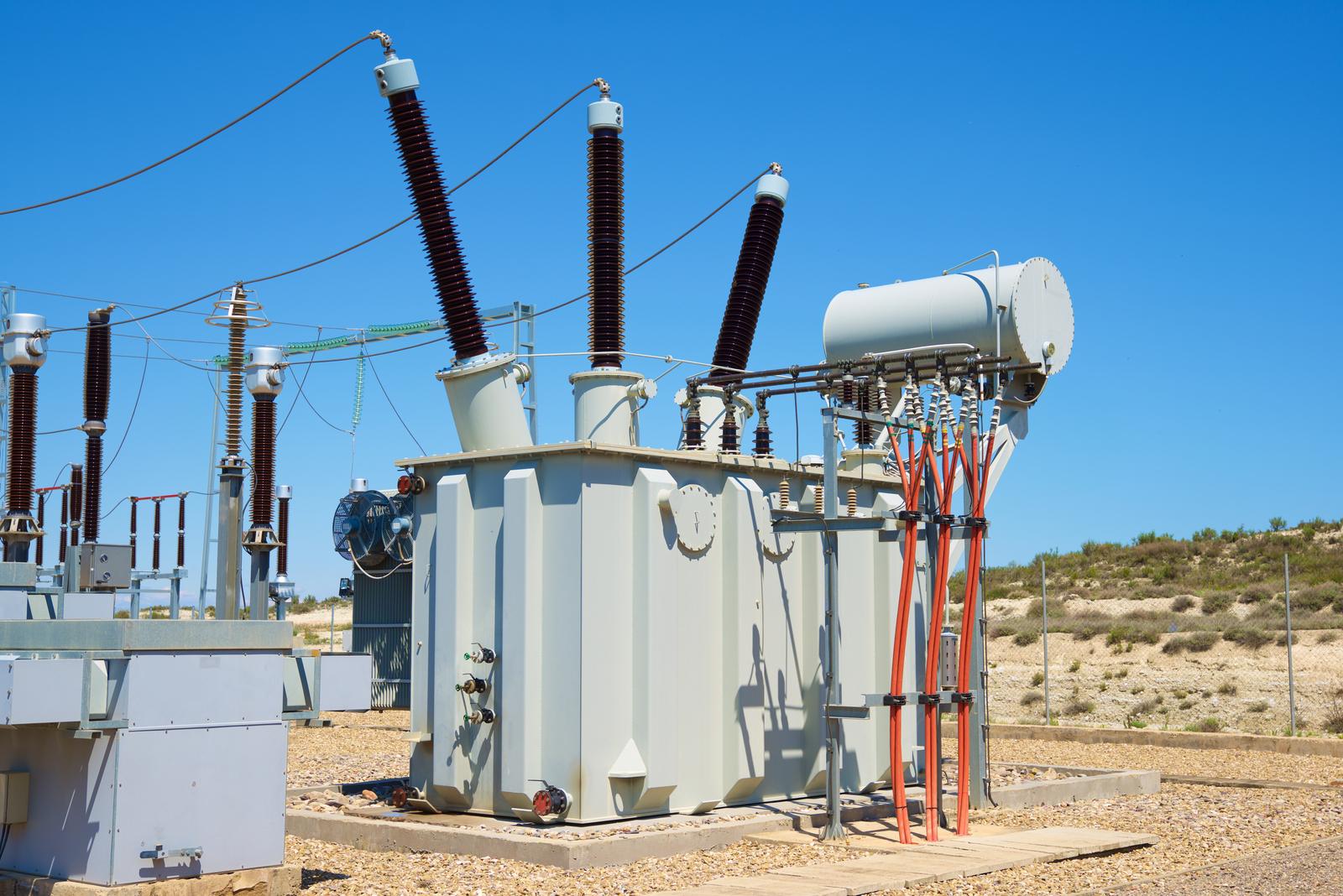 Closeup of electrical substation equipment and transformer infrastructure in a utility yard