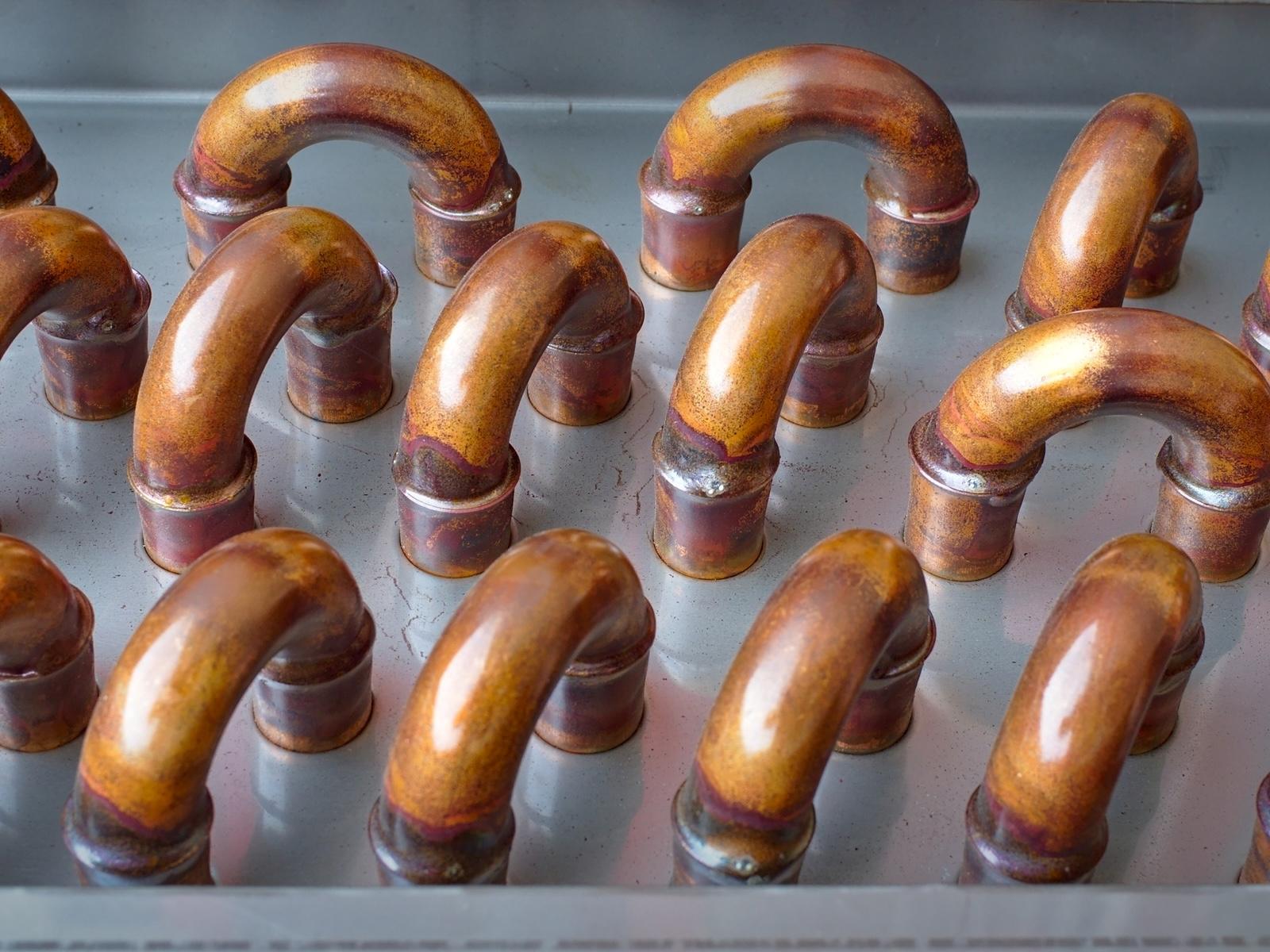 Copper piping and industrial thermal equipment detail representing clean surplus process cooling inventory