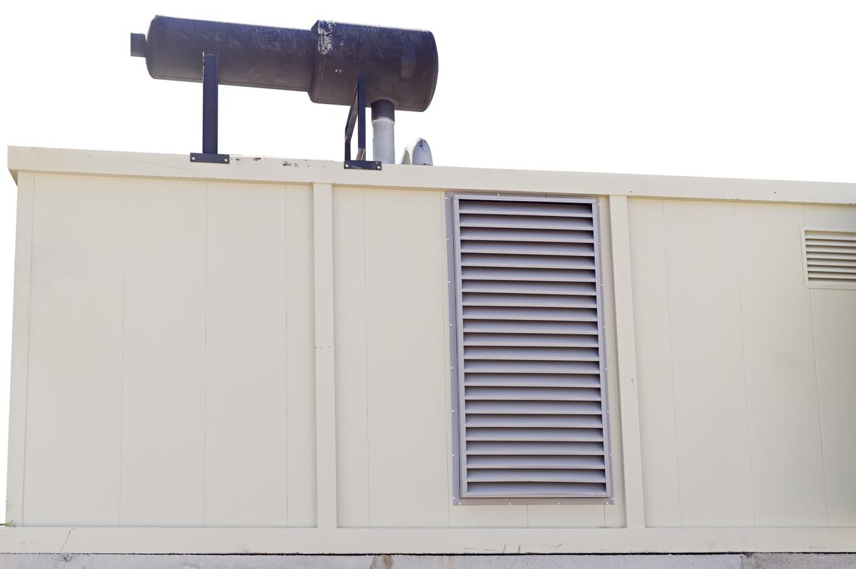 Exterior of industrial generator with ventilation enclosure representing standby or facility backup power equipment available for sale