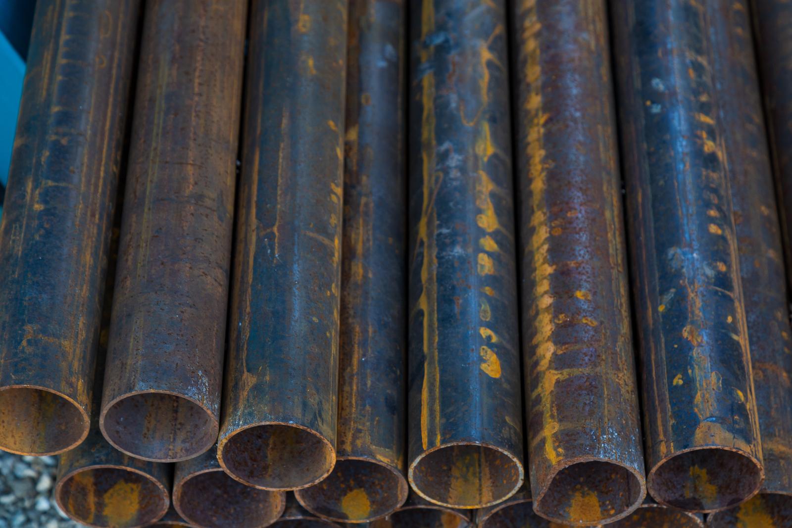 Industrial metal fittings and pipe products stored in a warehouse as surplus inventory