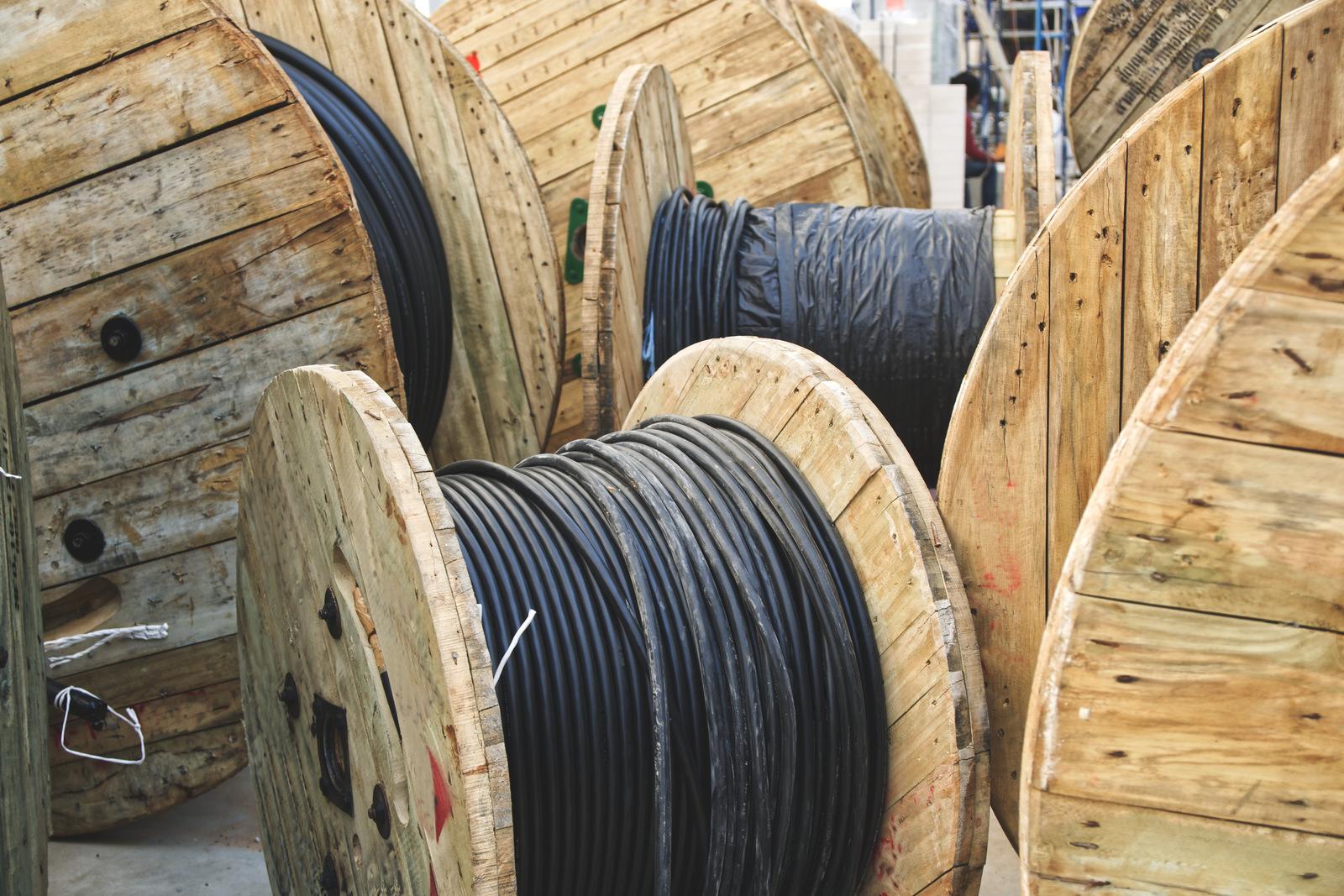 Factory electrical materials and cable spools staged during a facility upgrade or shutdown